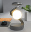Rotating Moon Desk Lamp with Wireless Charging providing ambient light for workspace decor.