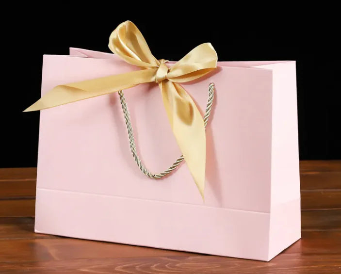 Bowknot Square Paper Bag in pink with a yellow bow and sturdy handle, perfect for eco-friendly gift presentation.