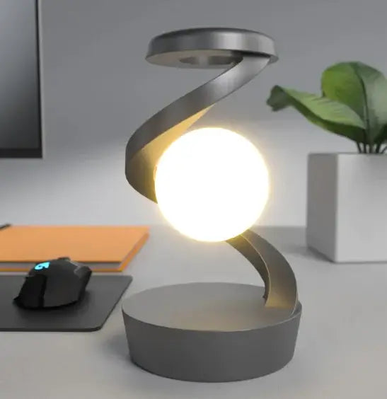 Rotating Moon Desk Lamp with Wireless Charging on a desk, featuring a sleek design and illuminated globe.