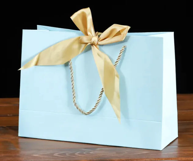 Bowknot Square Paper Bag in light blue with a gold bow knot and sturdy handles, perfect for eco-friendly gifting.