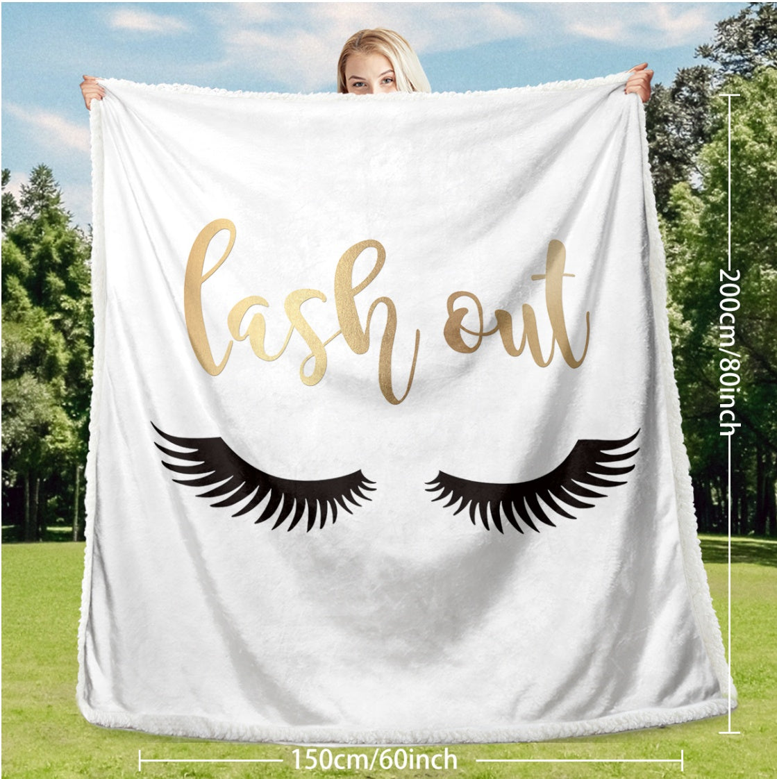 Flannel Velvet Blanket Long Eyelashes displayed outdoors, showcasing its cozy reversible design and cute 'lash out' print.