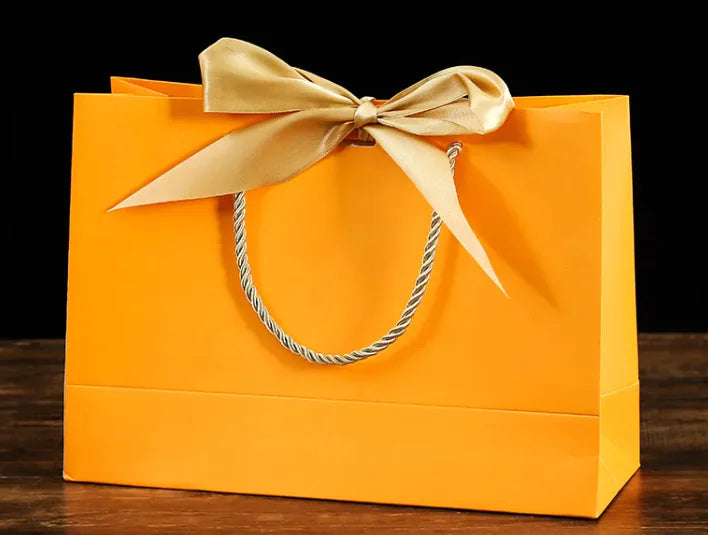Bowknot Square Paper Bag in vibrant orange with a gold bow, perfect for stylish gift presentation.