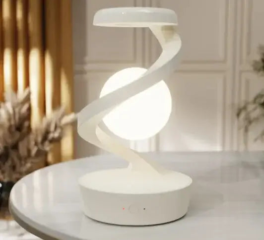 Rotating Moon Desk Lamp with Wireless Charging on a table, featuring a sleek design and illuminated globe.