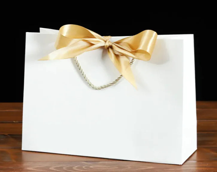 Bowknot Square Paper Bag with a gold bow, showcasing its eco-friendly design and sturdy square shape.