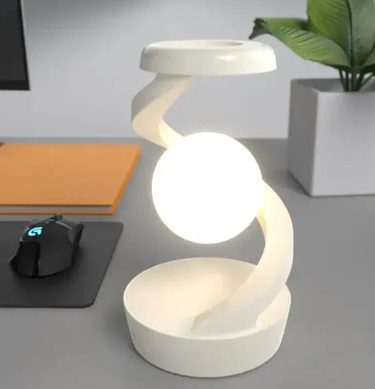 Rotating Moon Desk Lamp with Wireless Charging in a modern white design illuminating a workspace.