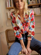 Women's Shirt Long Sleeved Shirt Casual Printed Flower Shirt worn by a woman, featuring colorful floral patterns and a button front.
