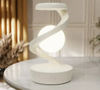 Rotating Moon Desk Lamp with Wireless Charging on a table, featuring a sleek design and illuminated globe.