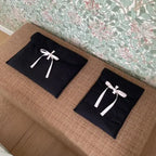 Women’s Ballet Bow Quilted Laptop Bag – Elegant 15” Computer Bag in elegant black with ribbons on a stylish surface.