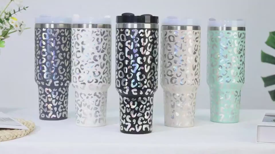 40oz Insulated Stainless Steel Tumbler Handle Straw Lid in assorted colors and designs on a table.